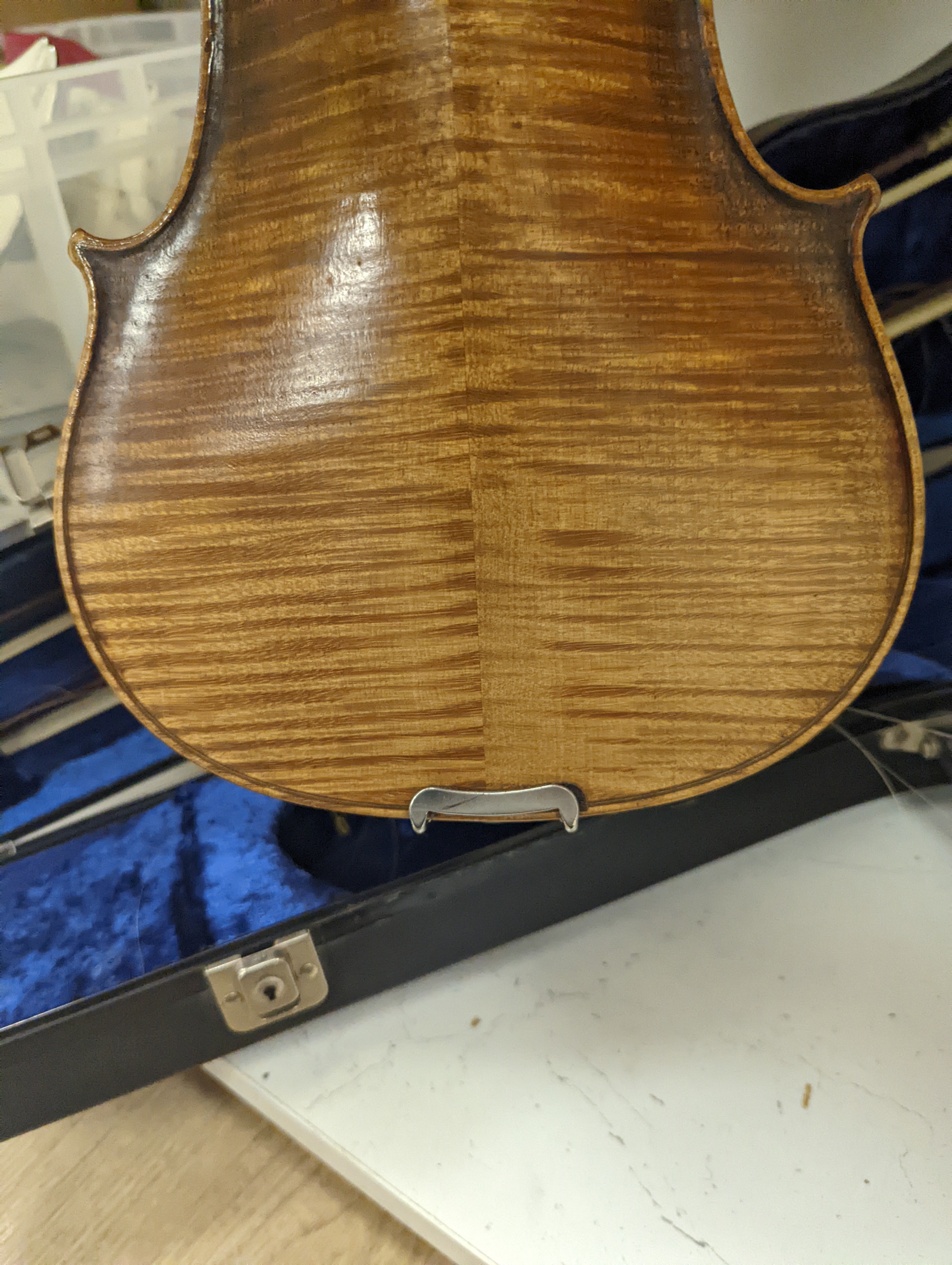 An early 20th century French or English violin with two bows, each stamped